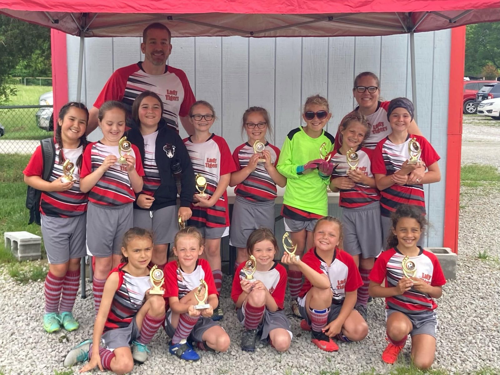 Bethel girls soccer team with trophies and coaches